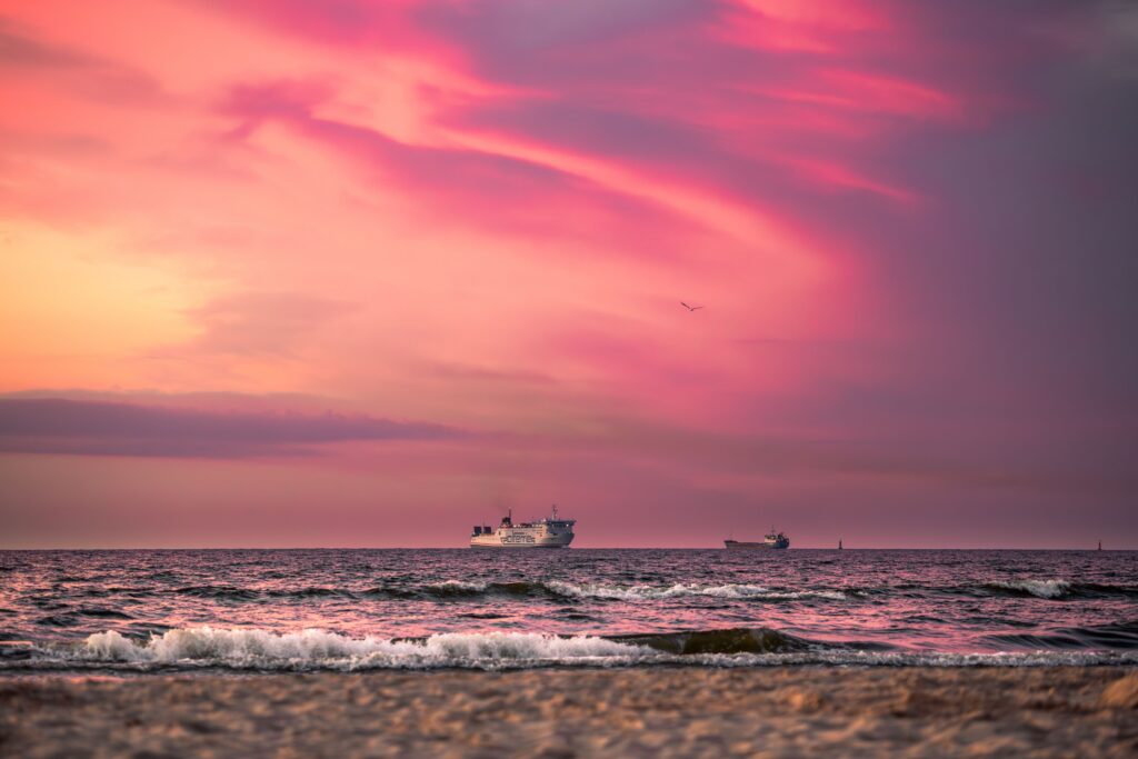 Captivating sunset with ships on the Baltic Sea at Świnoujście, Poland.