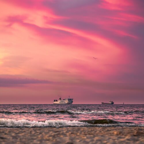 Captivating sunset with ships on the Baltic Sea at Świnoujście, Poland.