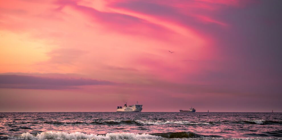 Captivating sunset with ships on the Baltic Sea at Świnoujście, Poland.